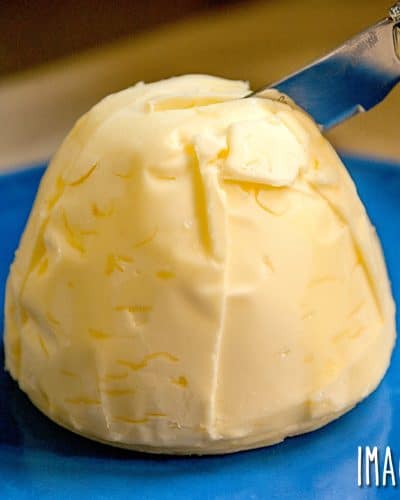 homemade butter formed into a ball on a blue plate
