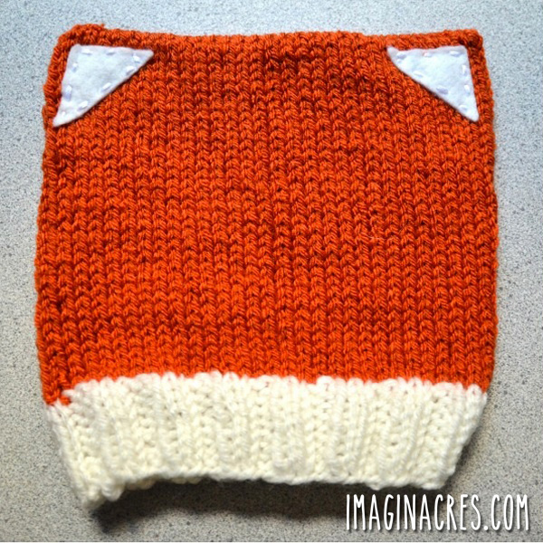 knitted fox hat on a grey background