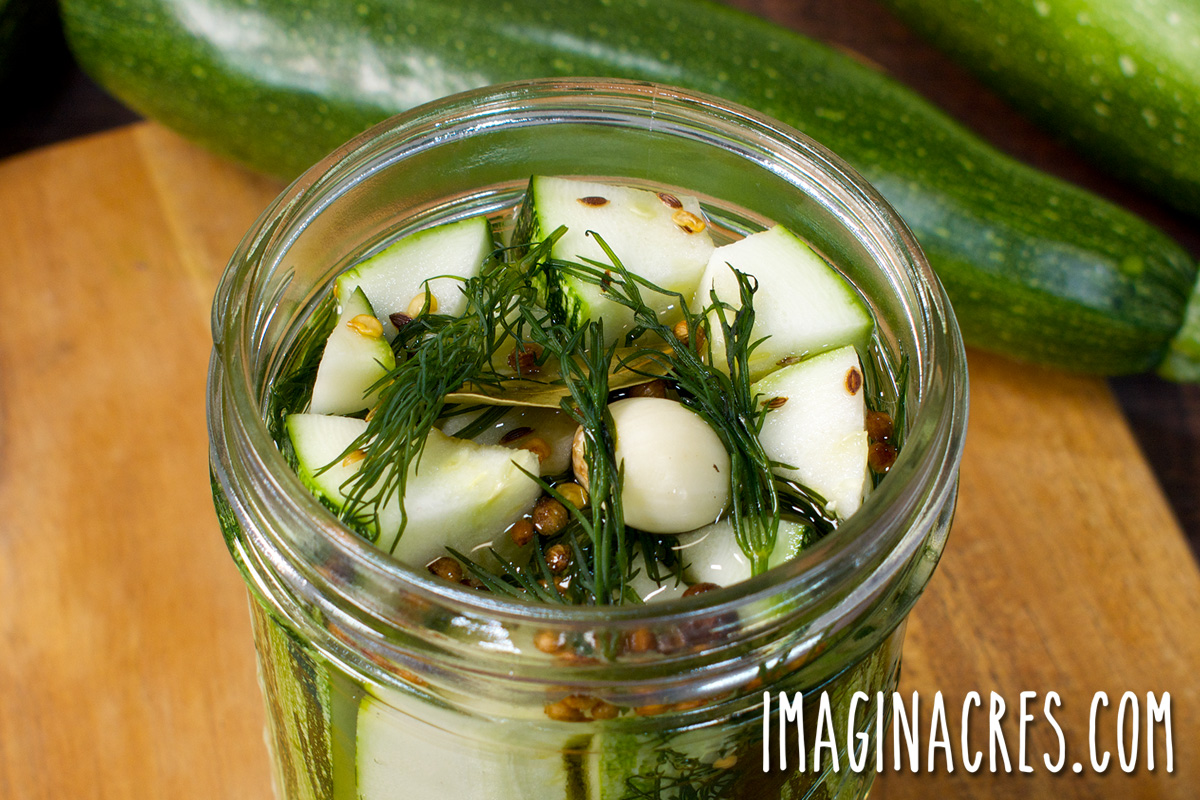 Close up of an open jar of zucchini pickles after adding the pickling liquid.