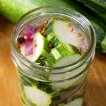 Close up of a jar of bread and butter zucchini pickles.